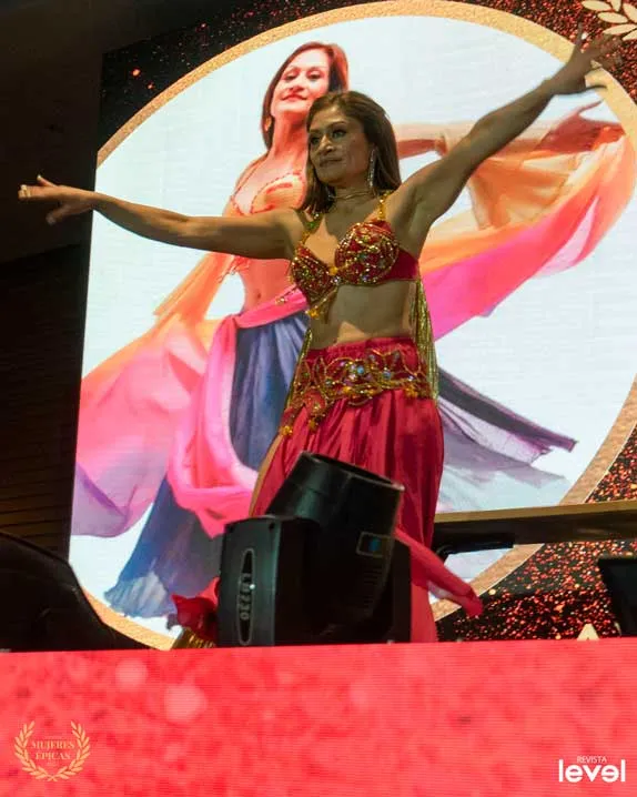 Bailarina de danza del vientre con velos de colores en el escenario de Mujeres Épicas de Revista Level