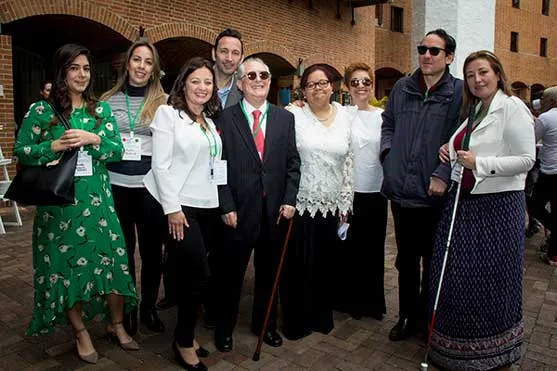 Grupo de personas posa en un patio de ladrillo, dos de ellas con bastón, en el Foro Negocios Conscientes